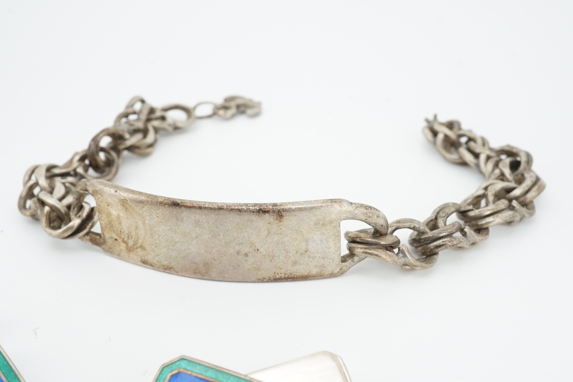 A 1970's silver identity bracelet and a modern pair of silver and two colour enamel cufflinks.